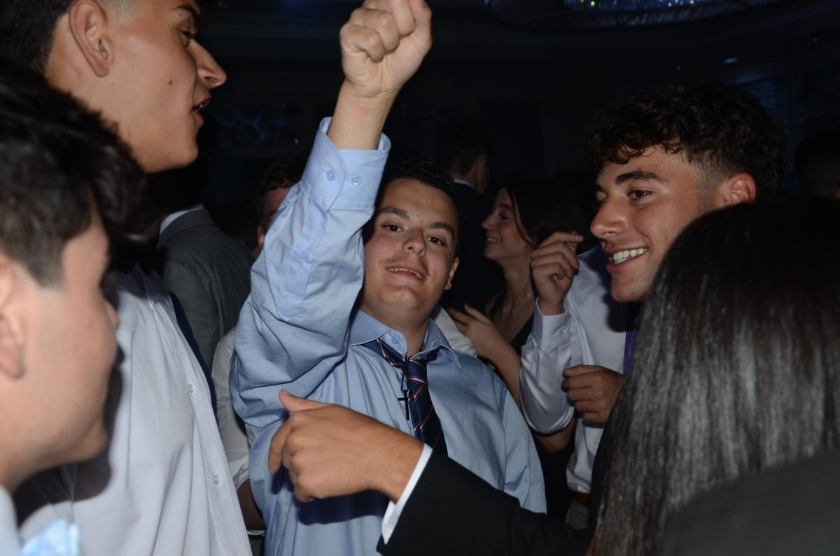 Senior Ryan Bell (center) celebrates with friends at the prom.