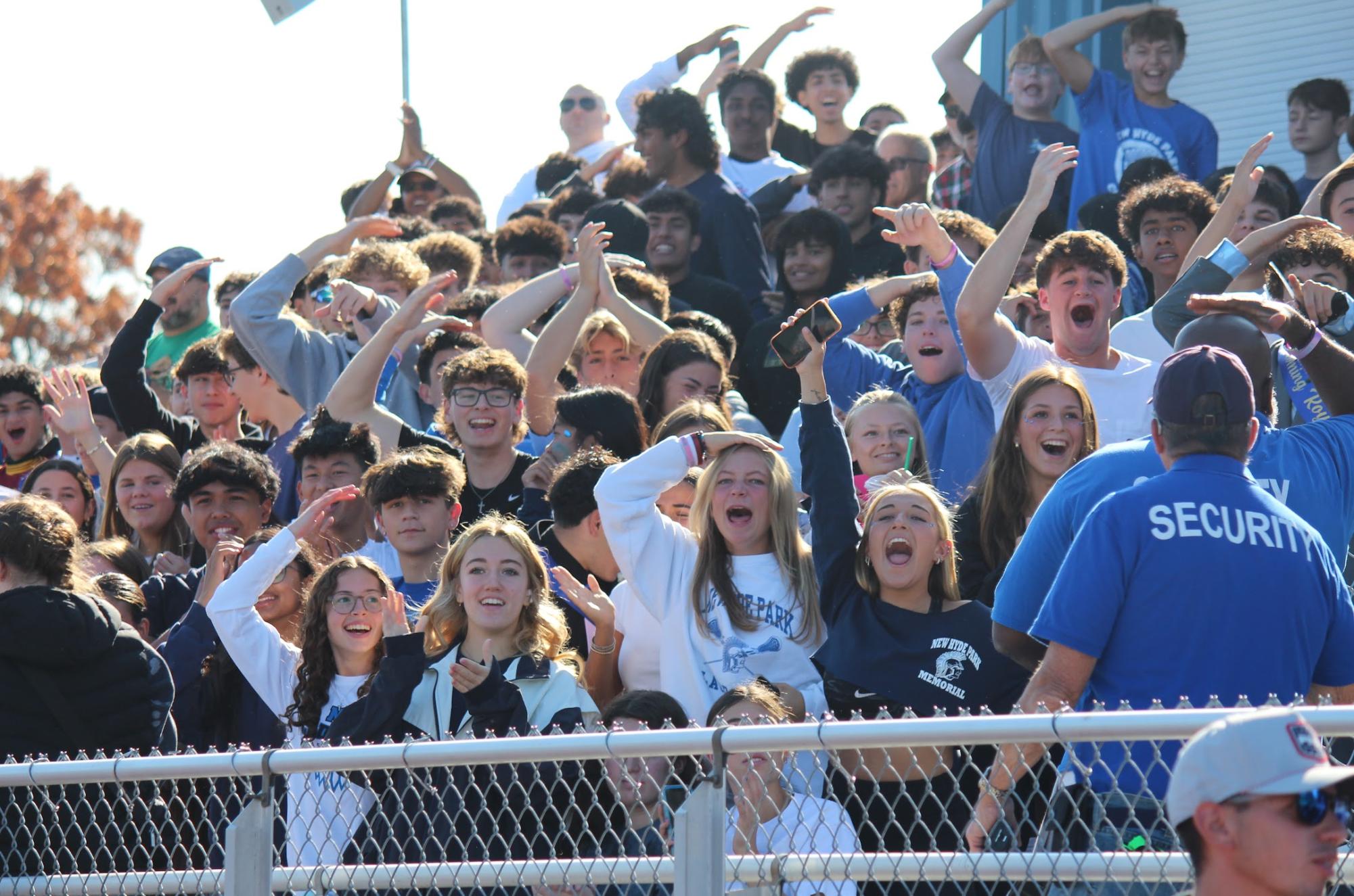 Students cheer during the first touchdown of the Homecoming game.