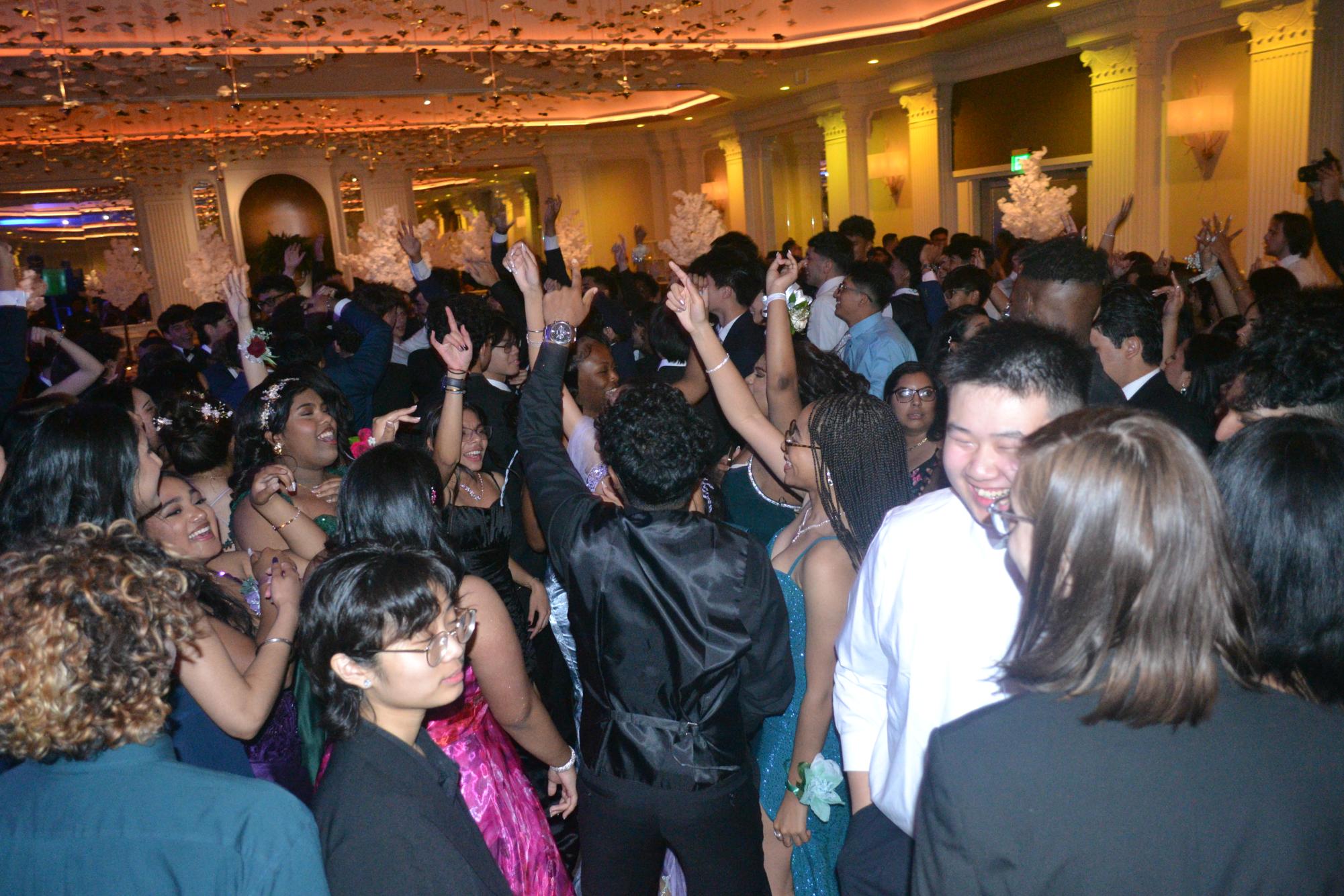 Seniors kick off their prom party by dancing on the dance floor. 