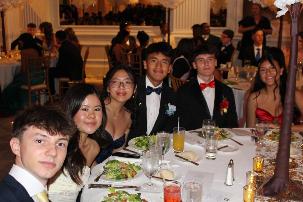 Students pose with their friends as they are seated for their first course. 