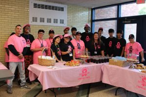 Ms. Taryn Doyle poses with students after preparing for coffee sale.
