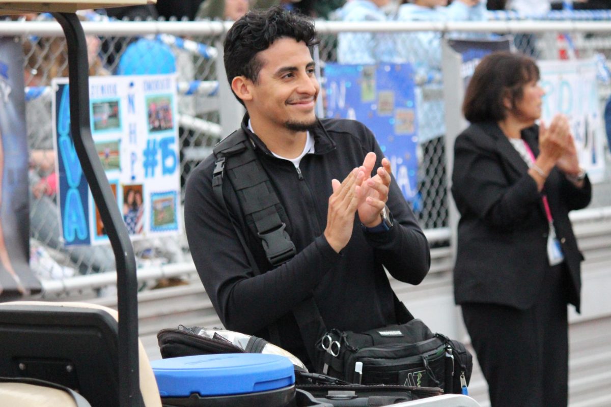 Athletic trainer David Lebron stands by at NHP football game.