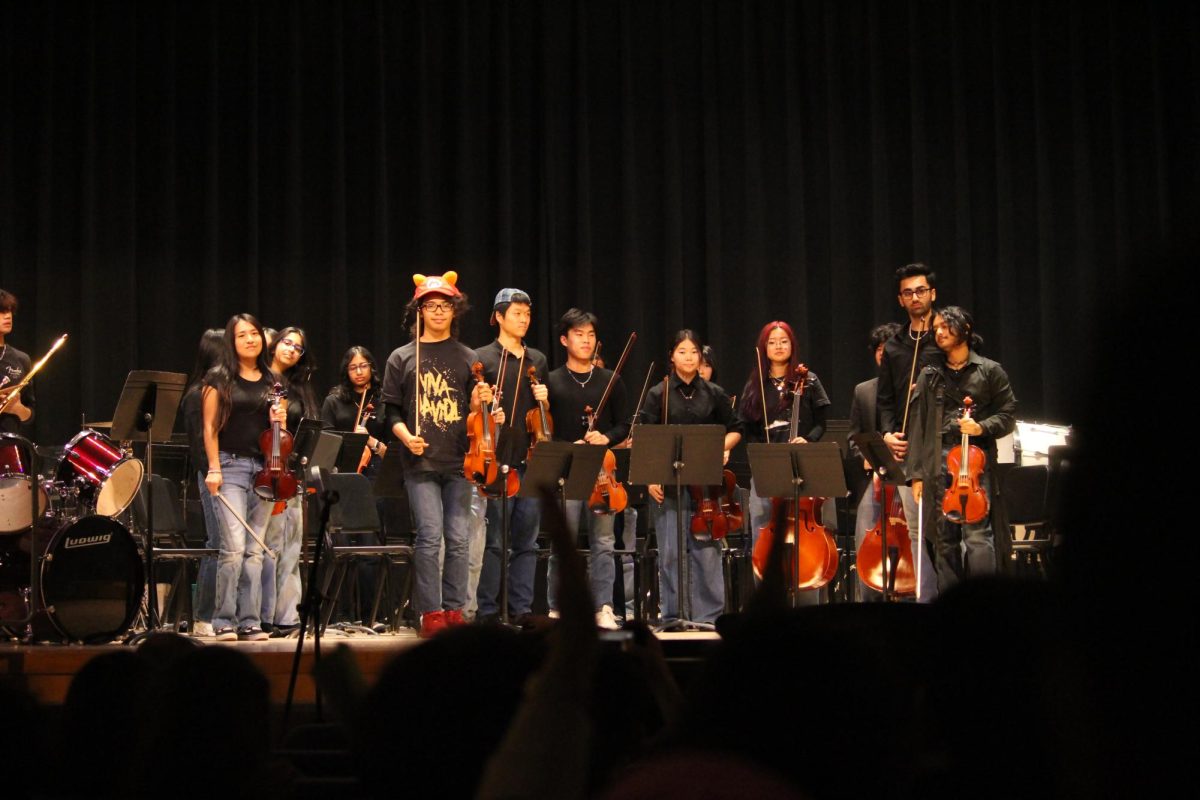 ABC string members receive applause from the audience after a performance.