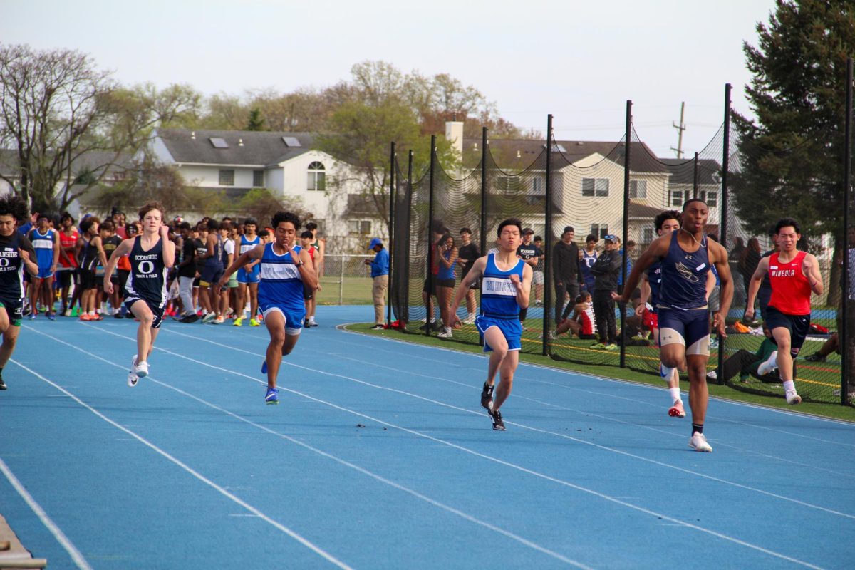 Jorden Jacob and Justin Li run the 100-meter dash during a meet.