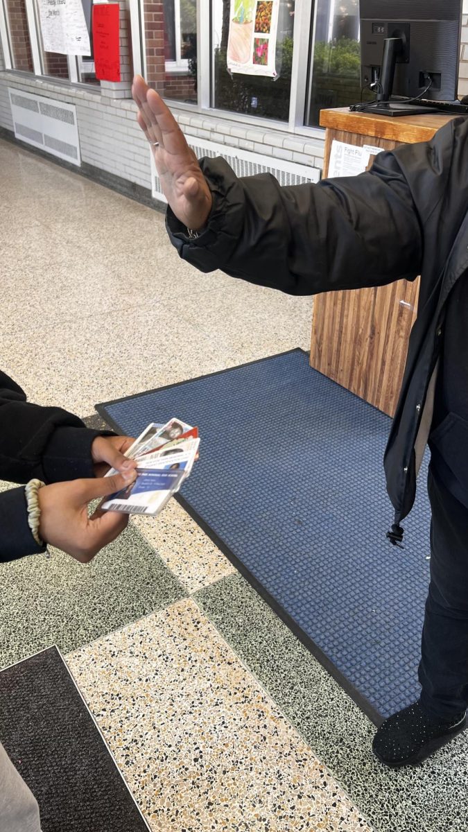Student being stopped at the entrance being asked to verify their identity using multiple forms of ID. 