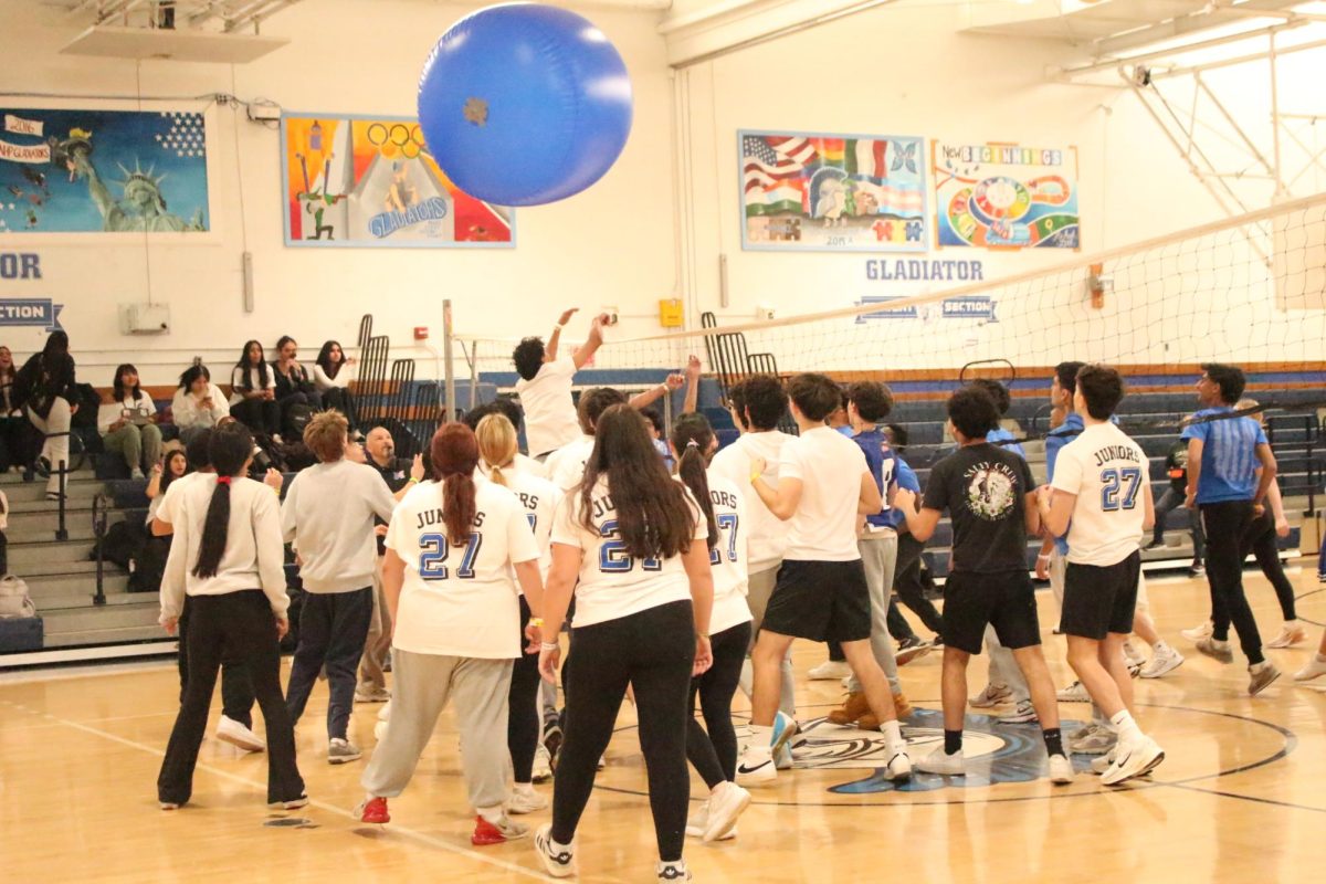 The juniors and seniors are caught in a heated rivalry during cage volleyball.