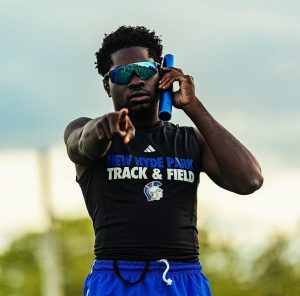 Senior Alex Grant poses for a photo, capturing a moment of becoming a record holder of the 100 and 200 meter dashes.