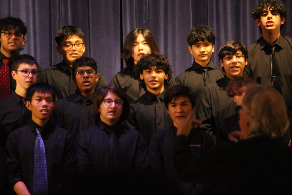 Music teacher Mr. McLeer directs NHP Chamber Singers during the winter concert.