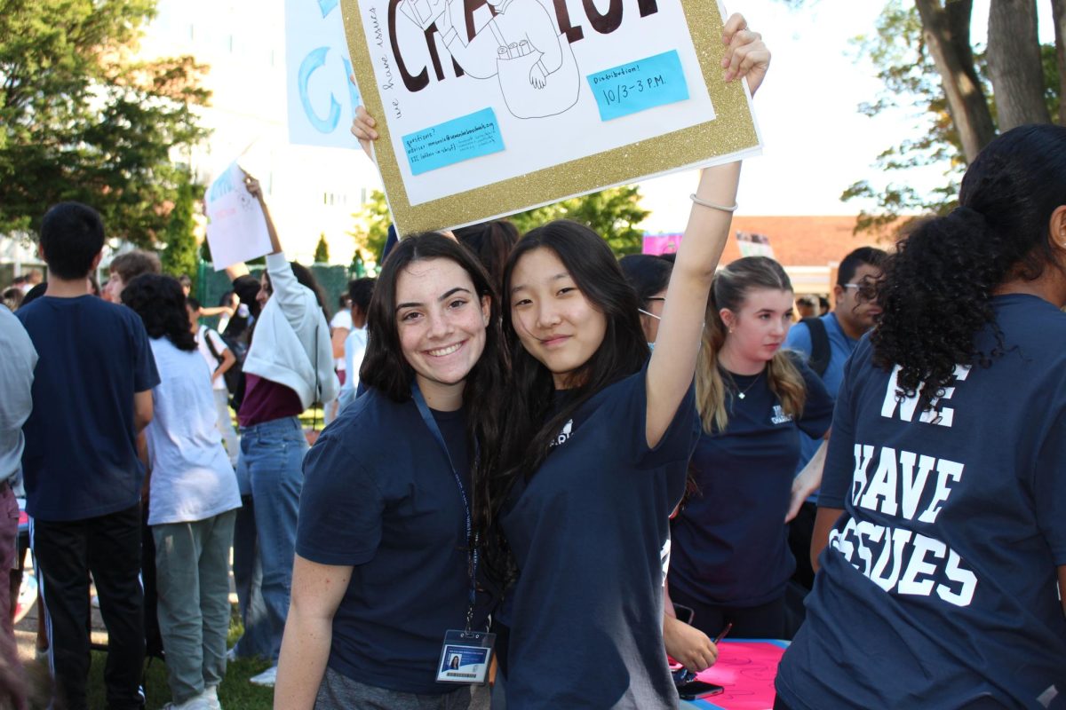 Tina Torre (left) and Rachel Houng recruit staffers for The Chariot at the club fair.